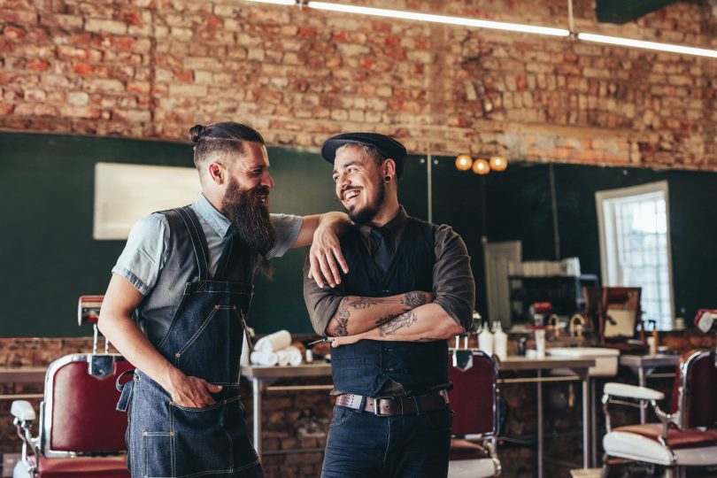 Barbers in barber shop chatting