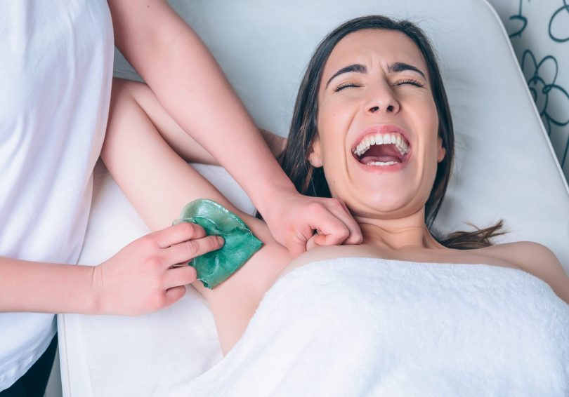 Lady in pain having a waxing treatment